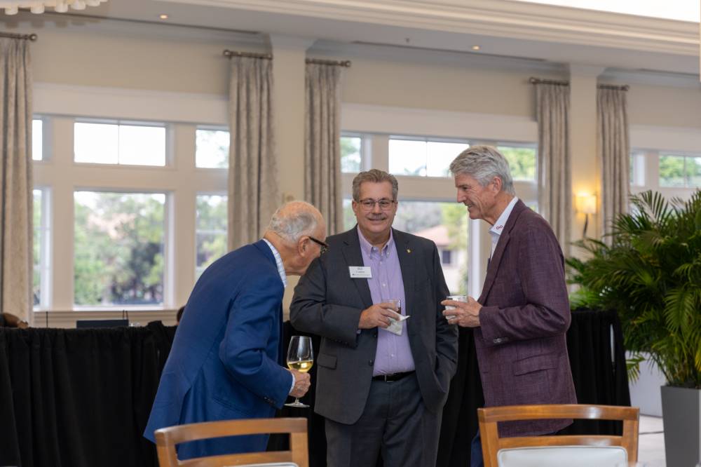 Bill Coderre standing in conversation with two other guests